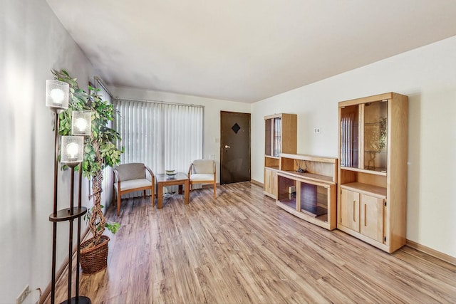 living area featuring light hardwood / wood-style flooring and a healthy amount of sunlight