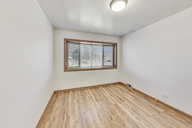 spare room with light hardwood / wood-style flooring