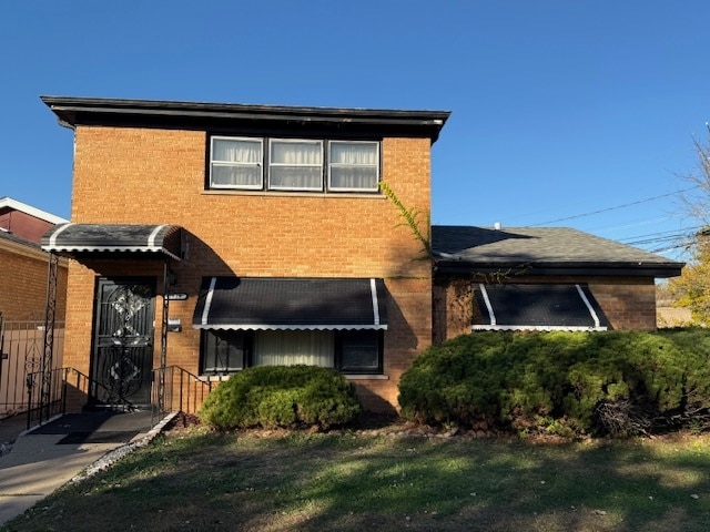 rear view of property featuring a yard