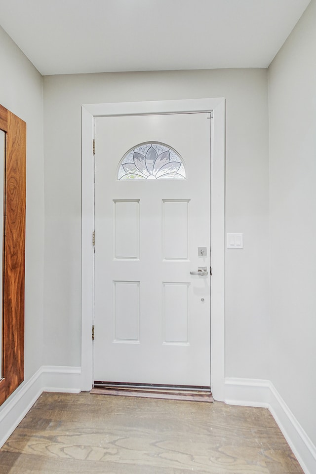 entryway with hardwood / wood-style floors