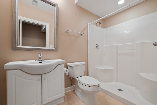 bathroom with toilet, vanity, tile patterned floors, and walk in shower