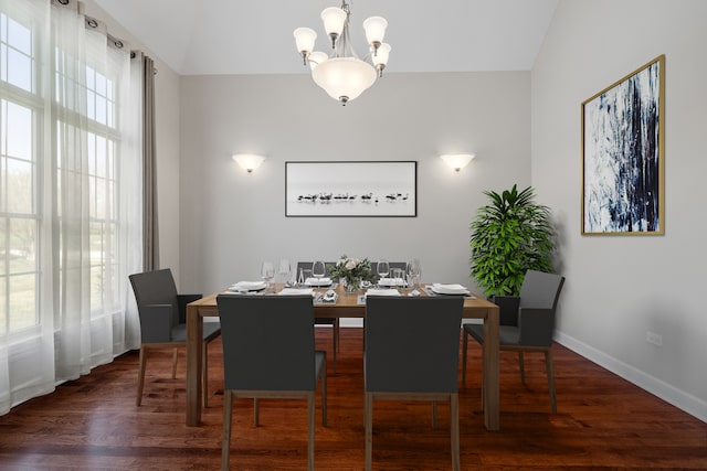 dining area with vaulted ceiling, a notable chandelier, and dark hardwood / wood-style flooring