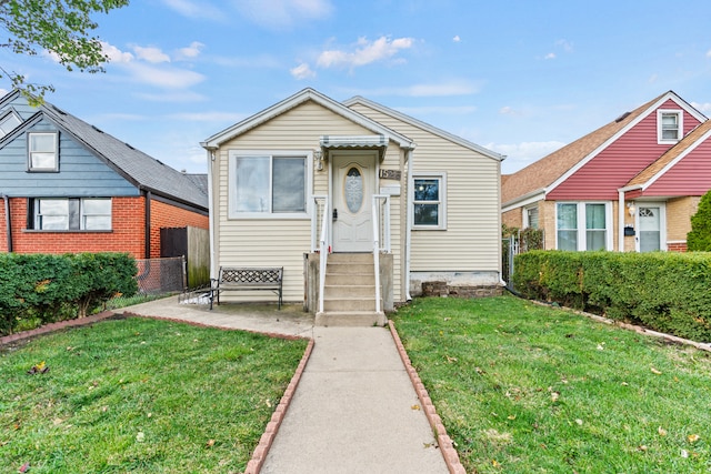 bungalow-style home featuring a front lawn