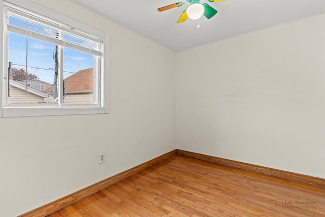 empty room with crown molding, ceiling fan, and light wood-type flooring