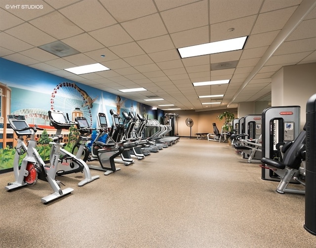 gym with carpet floors and a drop ceiling