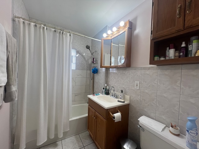 full bathroom featuring shower / bathtub combination with curtain, tile patterned floors, toilet, vanity, and tile walls