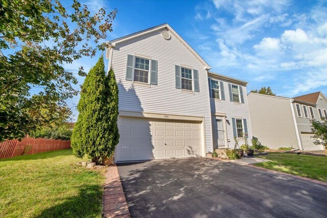 view of front of house featuring a front yard and a garage