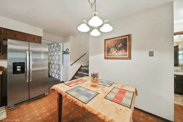 dining area featuring dark hardwood / wood-style floors and a notable chandelier