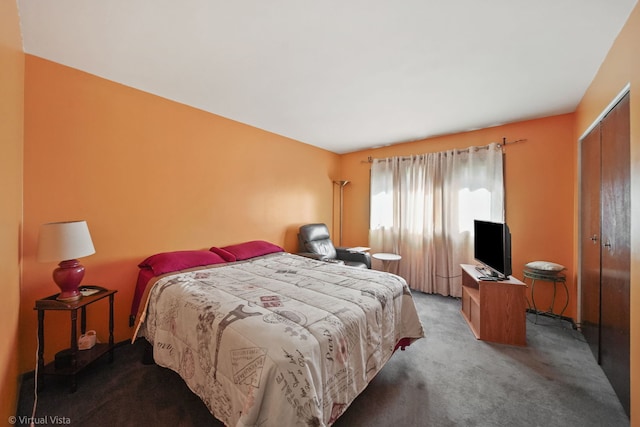 carpeted bedroom with a closet