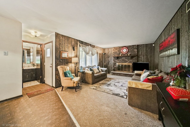 living room featuring wooden walls and a brick fireplace