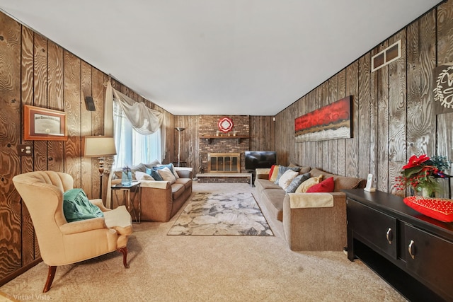 living room with a fireplace, light carpet, and wood walls