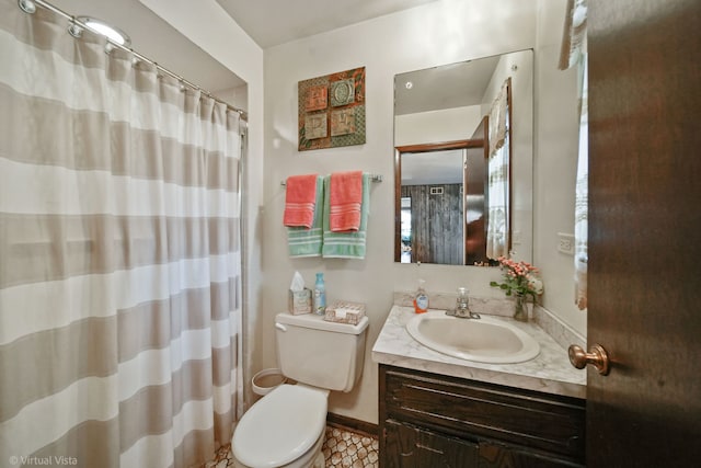 bathroom featuring tile patterned flooring, vanity, and toilet