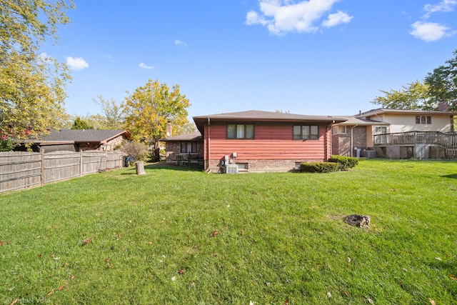 rear view of property featuring a lawn