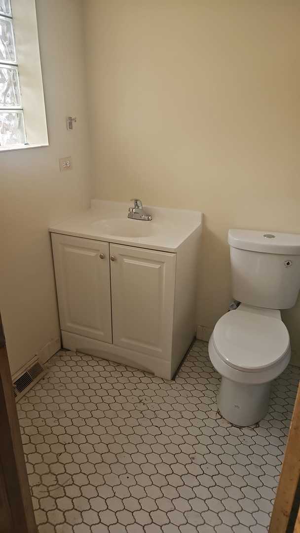 bathroom with tile patterned floors, vanity, and toilet