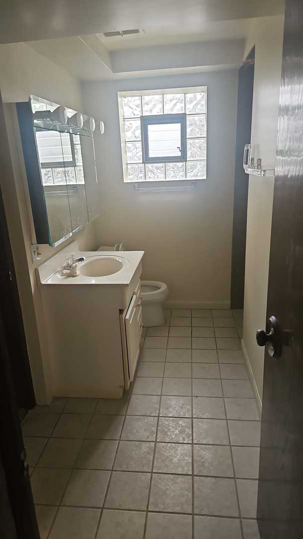 bathroom featuring tile patterned floors, vanity, and toilet