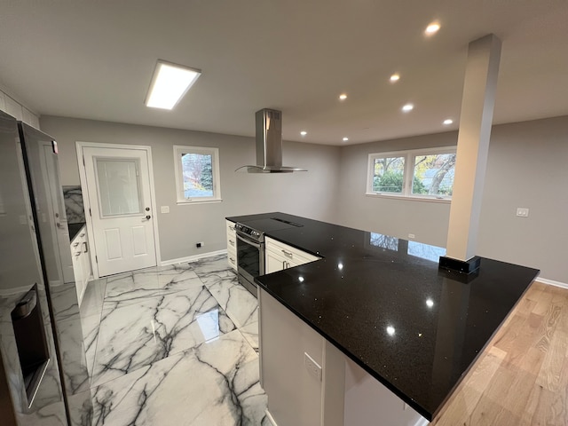 kitchen with extractor fan, a wealth of natural light, stainless steel range with electric stovetop, and light hardwood / wood-style floors