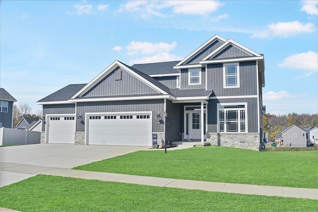 craftsman-style house featuring a garage and a front yard