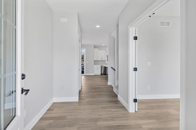 corridor featuring light hardwood / wood-style floors