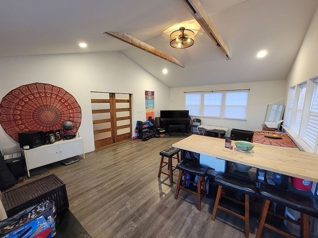 dining area featuring vaulted ceiling and dark hardwood / wood-style floors