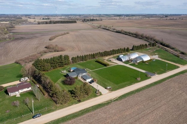 birds eye view of property with a rural view