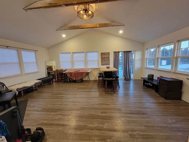 interior space featuring beam ceiling, dark hardwood / wood-style flooring, and high vaulted ceiling