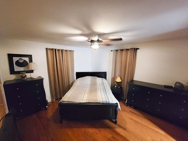 bedroom with wood-type flooring and ceiling fan