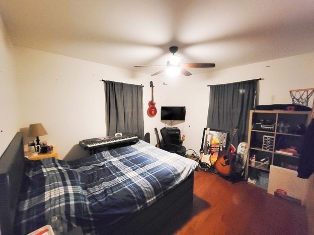 bedroom featuring ceiling fan and dark hardwood / wood-style floors