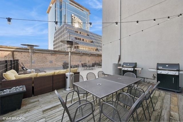 deck featuring a grill and an outdoor hangout area