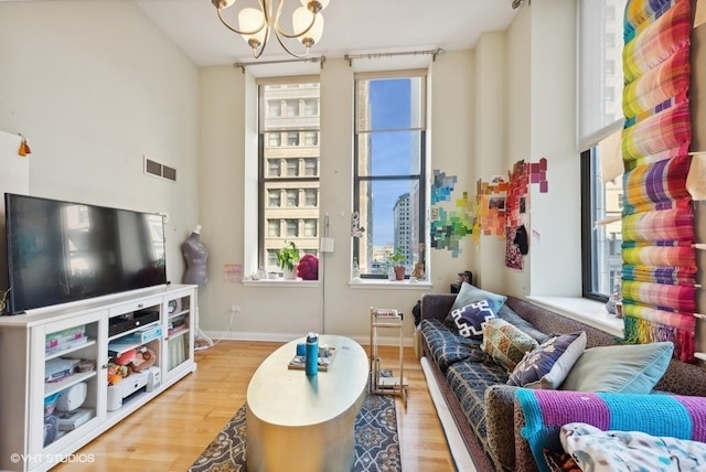 living room with a chandelier and light hardwood / wood-style floors