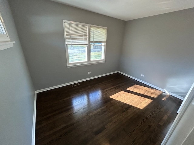 empty room with dark wood-type flooring