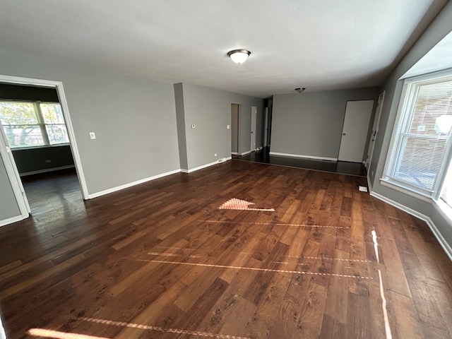 empty room with dark hardwood / wood-style flooring