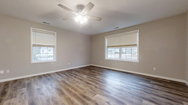 spare room with dark hardwood / wood-style floors and ceiling fan