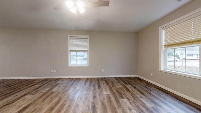 unfurnished room with ceiling fan, plenty of natural light, and dark hardwood / wood-style floors