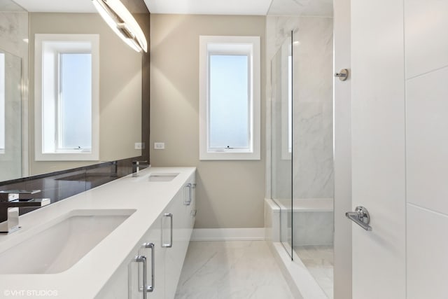 bathroom with vanity and tiled shower