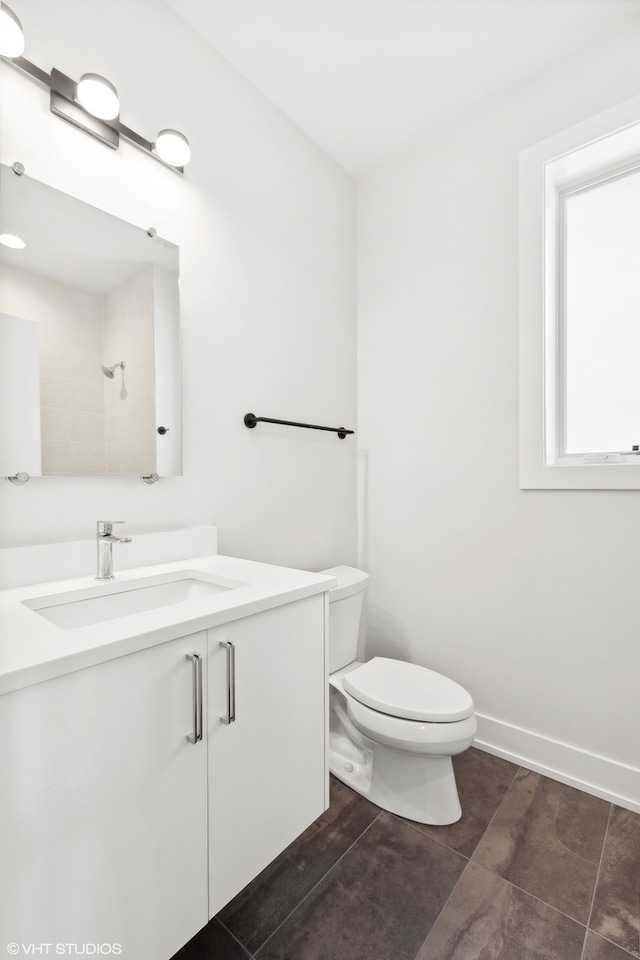 bathroom with tile patterned flooring, vanity, and toilet