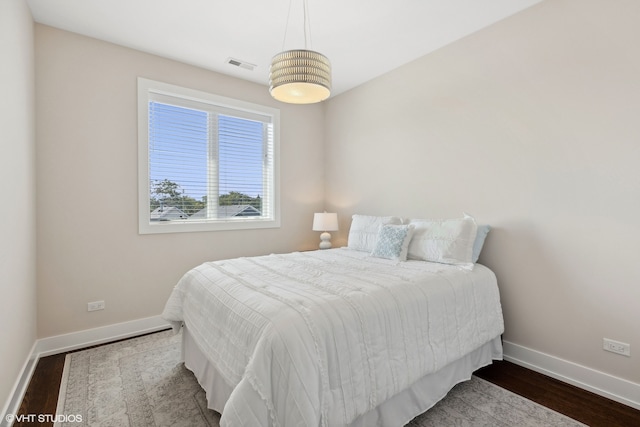 bedroom with hardwood / wood-style floors