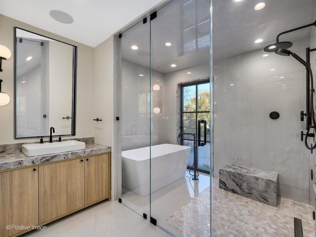 bathroom featuring vanity and plus walk in shower