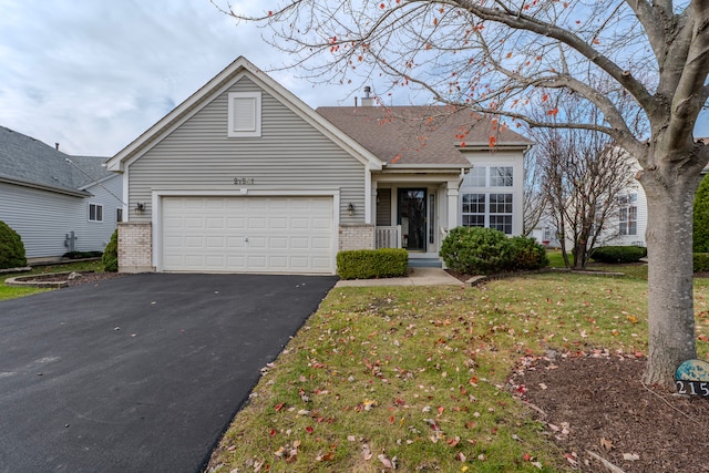 view of front of property with a garage and a front lawn