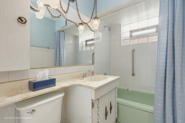 bathroom with backsplash, vanity, plenty of natural light, and shower / bathtub combination with curtain