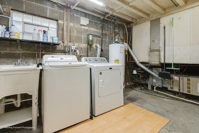 laundry area with washing machine and clothes dryer and gas water heater