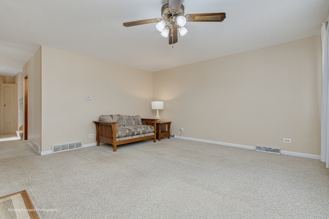 sitting room featuring carpet and ceiling fan