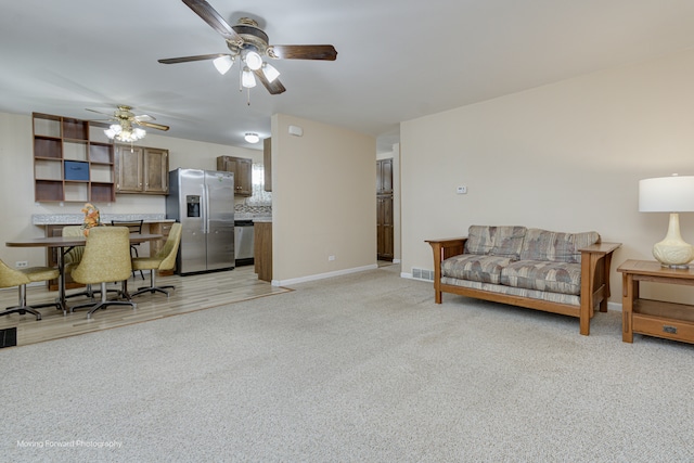 carpeted living room featuring ceiling fan