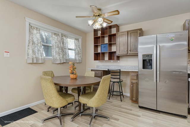 dining space with ceiling fan and light hardwood / wood-style floors