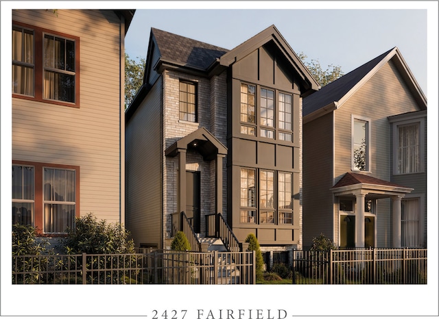 view of front facade featuring brick siding and a fenced front yard