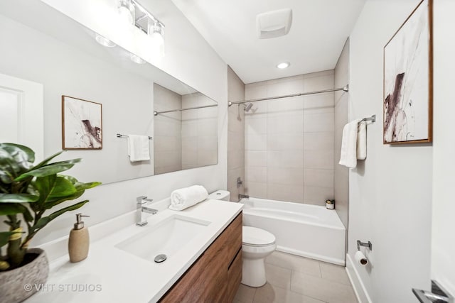 full bathroom featuring toilet, tiled shower / bath combo, tile patterned floors, and vanity