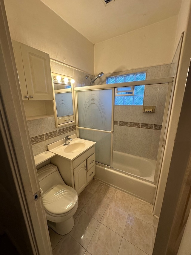 full bathroom with decorative backsplash, vanity, enclosed tub / shower combo, tile patterned flooring, and toilet