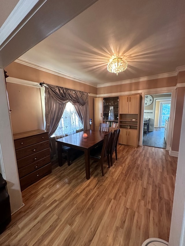 unfurnished dining area featuring crown molding, dark hardwood / wood-style flooring, and a chandelier