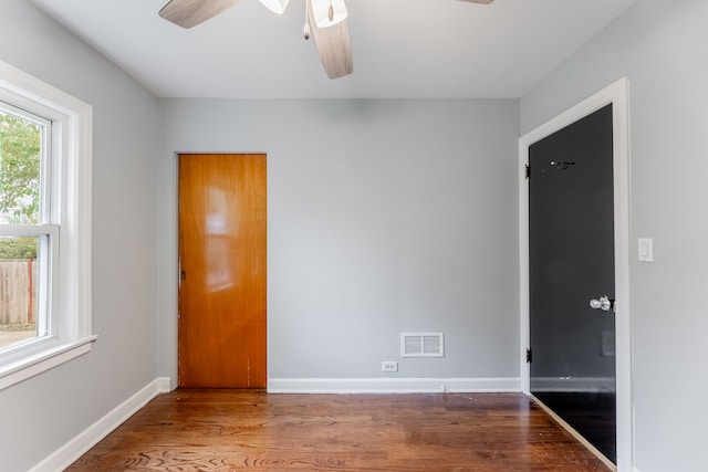 empty room with hardwood / wood-style flooring and ceiling fan