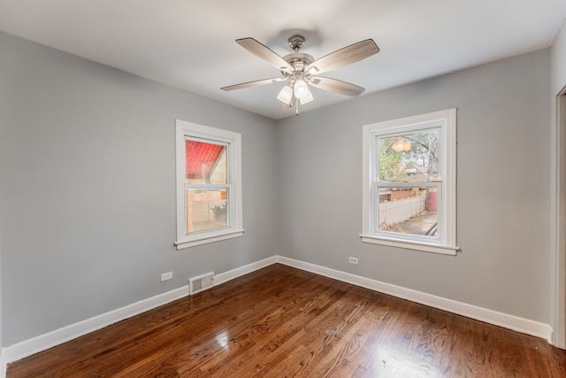 empty room featuring hardwood / wood-style flooring and ceiling fan