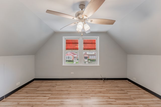 additional living space featuring ceiling fan, light hardwood / wood-style flooring, and vaulted ceiling